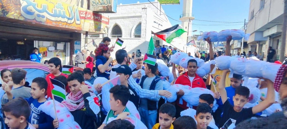  مسيرة "أكفان" تضامنا مع غزة في مخيم إربد