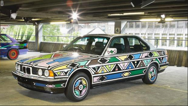 بالصور ..  بي إم دبليو تستعين بـ''عجوز أفريقية'' لتزيين بعض سياراتها